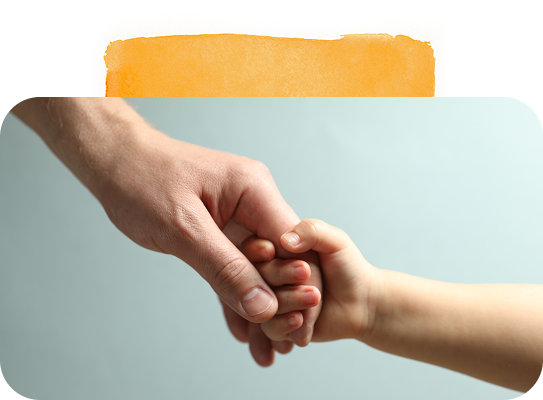 Adult hand gently holding a child’s hand