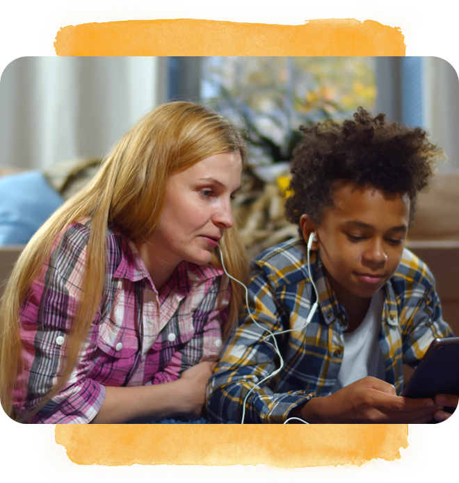Foster mother and child listening to music together with shared earphones.